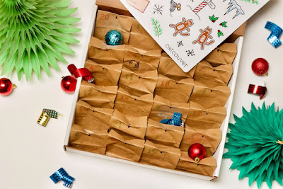 An advent calendar for cats is a box containing a set of brown bags with treats and toys