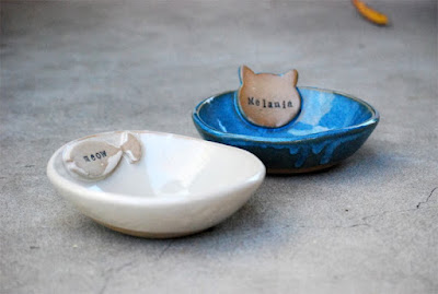 2 custom cat bowls, one blue with a cat head, one white with a fish, both personalized