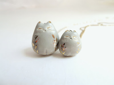 Two grey and gold porcelain cat pendant necklaces