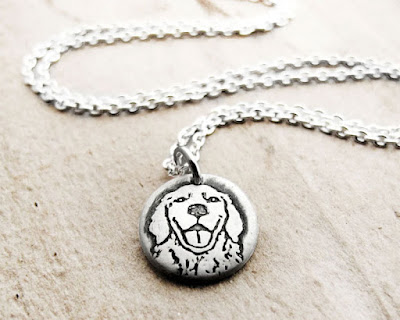 A Golden Retriever pendant on a silver chain